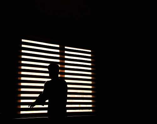 curtain man standing near window window